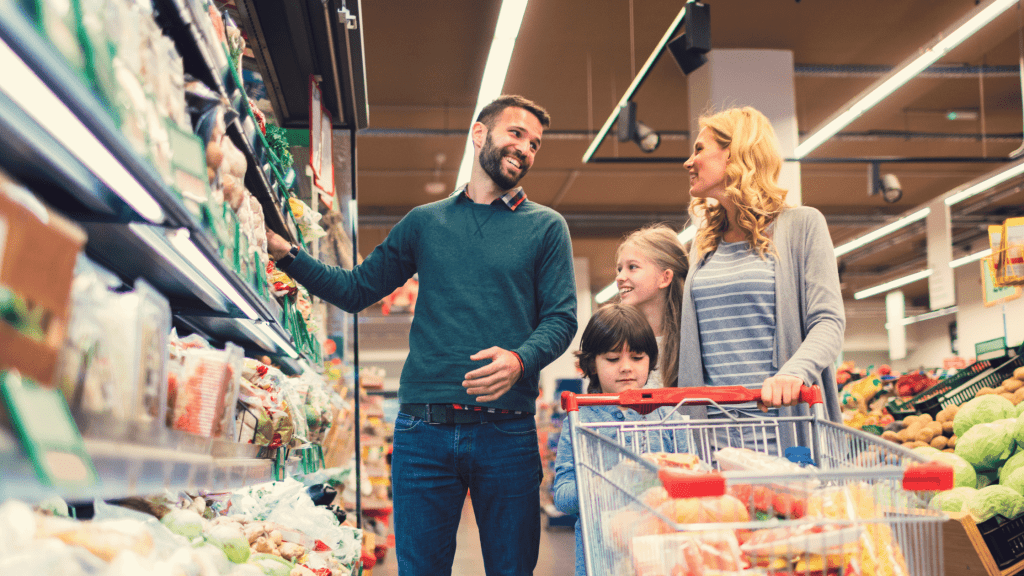 Record Low Annual Inflation Reported for July 2 Family in supermarket looking happy in reduction of food prices